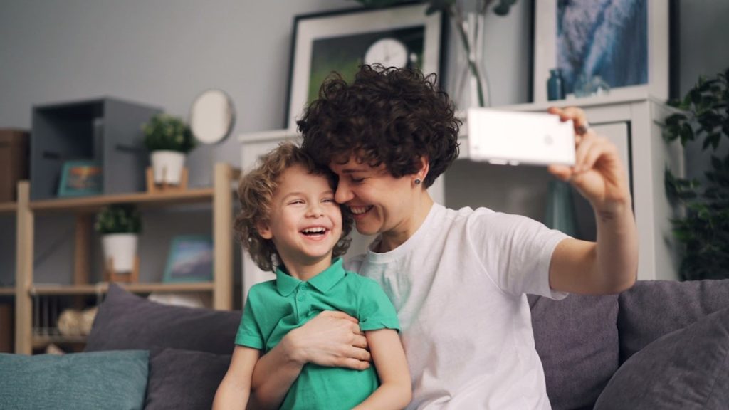 a man holding a little boy while he takes a picture