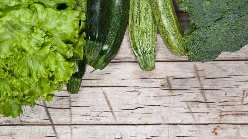 A group of vegetables sitting on top of a wooden table